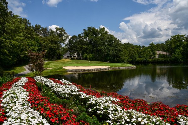 Dorchester golf green beside water with flowers in the foreground